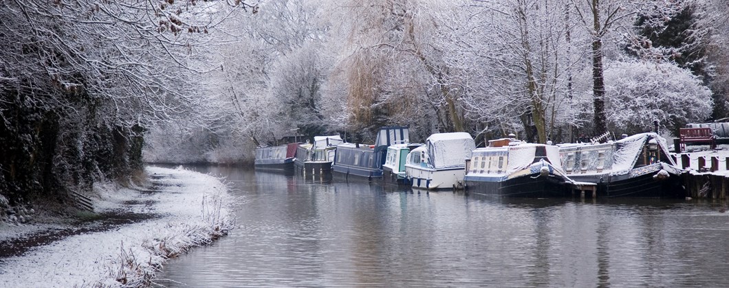 narrowboats riverboats on canal in winter